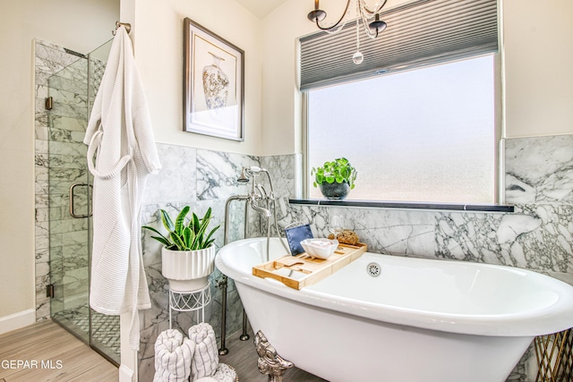 5705 Valley Lilac Ln, El Paso, TX 79932 - bathroom with tile walls, a freestanding bath, wood finished floors, a shower stall, and wainscoting