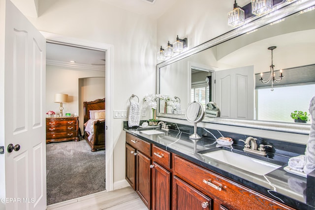 5705 Valley Lilac Ln, El Paso, TX 79932 - ensuite bathroom with double vanity, a chandelier, and crown molding