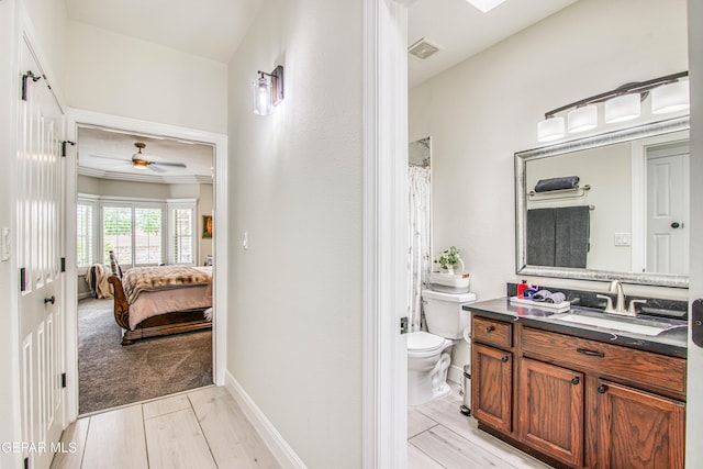 5705 Valley Lilac Ln, El Paso, TX 79932 - ensuite bathroom featuring vanity, ceiling fan, wood finished floors, crown molding, and curtained shower