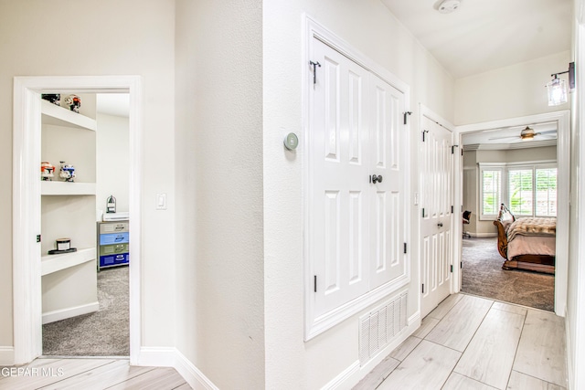 5705 Valley Lilac Ln, El Paso, TX 79932 - hall with wood finished floors and built in shelves