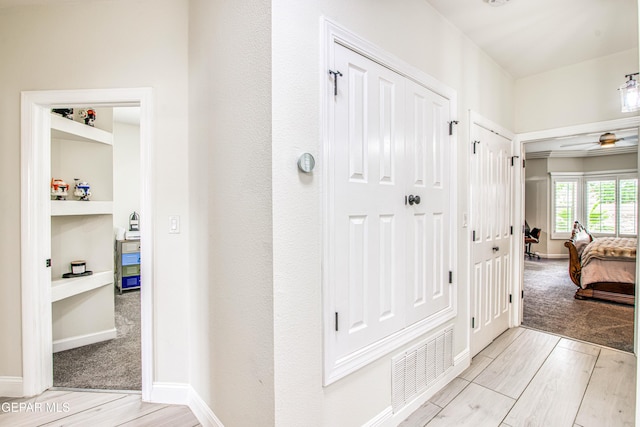 5705 Valley Lilac Ln, El Paso, TX 79932 - corridor with light wood-style flooring and light carpet