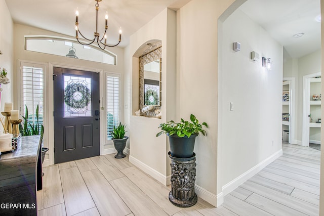 5705 Valley Lilac Ln, El Paso, TX 79932 - foyer with arched walkways, plenty of natural light, a chandelier, and light wood-style flooring