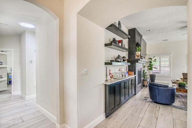 5705 Valley Lilac Ln, El Paso, TX 79932 - indoor dry bar with light wood-type flooring and arched walkways