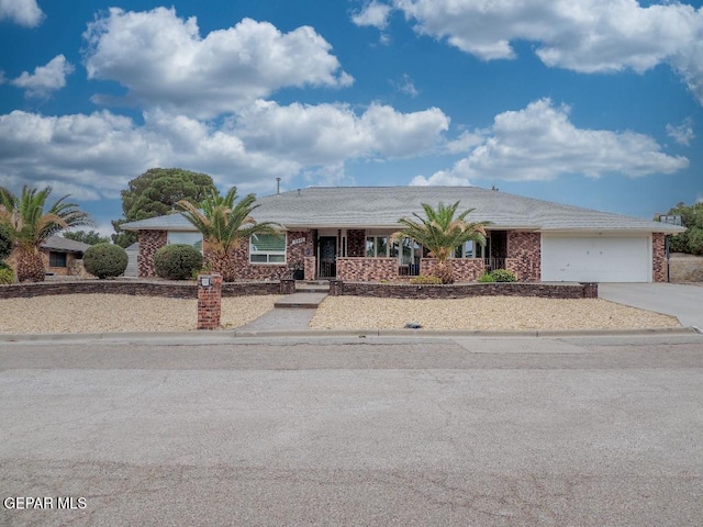 10945 Gary Player Dr, El Paso, TX 79935 - single story home featuring concrete driveway, a garage, and brick siding