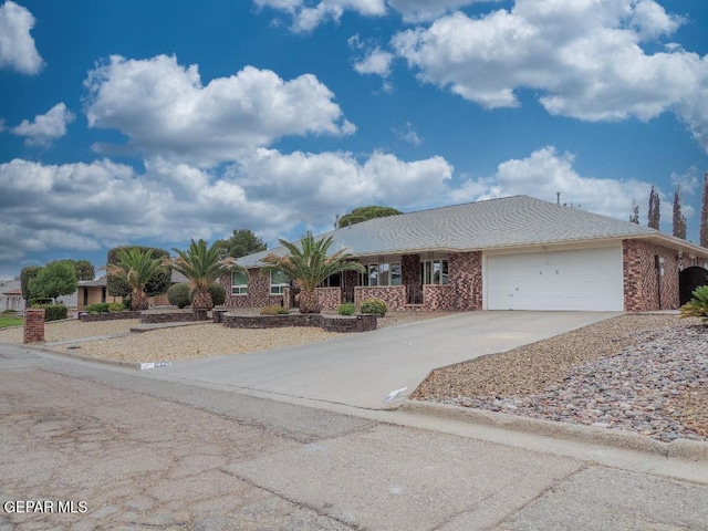 10945 Gary Player Dr, El Paso, TX 79935 - ranch-style home featuring an attached garage, concrete driveway, and brick siding