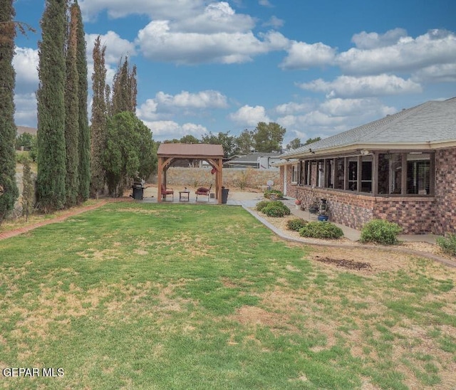 10945 Gary Player Dr, El Paso, TX 79935 - view of grassy yard featuring a gazebo and a patio area