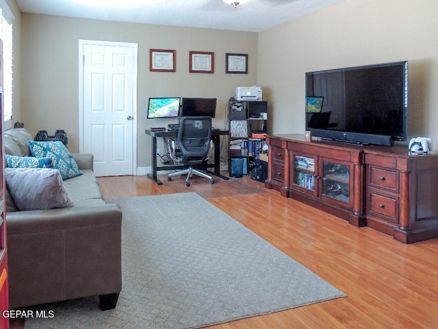 10945 Gary Player Dr, El Paso, TX 79935 - living area featuring wood finished floors and a desk