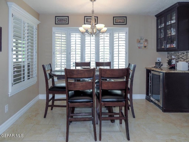 10945 Gary Player Dr, El Paso, TX 79935 - dining space with a chandelier, healthy amount of natural light, a bar, and beverage cooler
