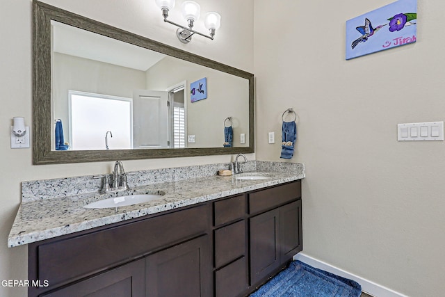 14753 Charles Foster Ave, El Paso, TX 79938 - full bathroom featuring double vanity and baseboards