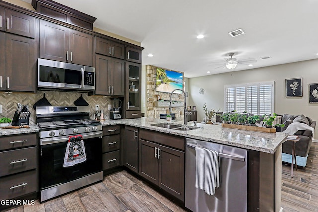 14753 Charles Foster Ave, El Paso, TX 79938 - kitchen with appliances with stainless steel finishes, a peninsula, open floor plan, dark brown cabinetry, and a ceiling fan