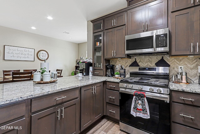 14753 Charles Foster Ave, El Paso, TX 79938 - kitchen featuring appliances with stainless steel finishes, dark brown cabinetry, tasteful backsplash, and recessed lighting