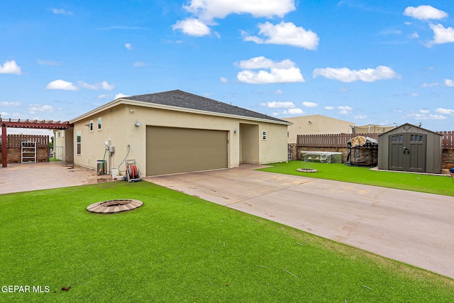 14753 Charles Foster Ave, El Paso, TX 79938 - view of front of property with a fire pit, stucco siding, a fenced backyard, a storage shed, and an attached garage