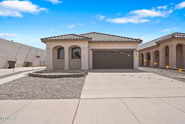 257 Farnborough St, El Paso, TX 79928 - mediterranean / spanish-style house featuring an attached garage, a tile roof, concrete driveway, and stucco siding