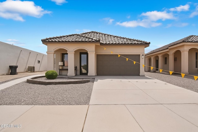 257 Farnborough St, El Paso, TX 79928 - mediterranean / spanish house featuring a garage, a tile roof, stucco siding, and driveway