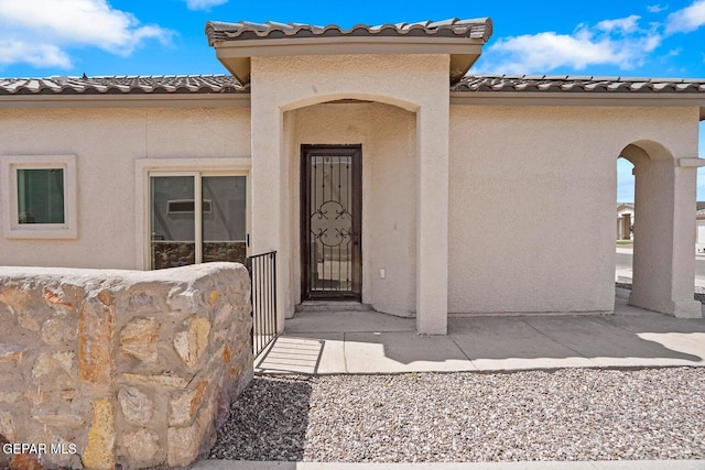 257 Farnborough St, El Paso, TX 79928 - property entrance featuring a tiled roof and stucco siding