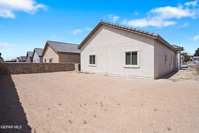 257 Farnborough St, El Paso, TX 79928 - rear view of property with stucco siding and a tile roof