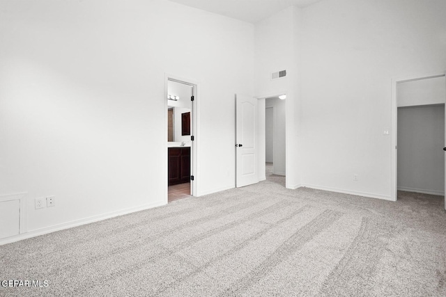 257 Farnborough St, El Paso, TX 79928 - unfurnished bedroom featuring carpet flooring, a towering ceiling, a walk in closet, and connected bathroom
