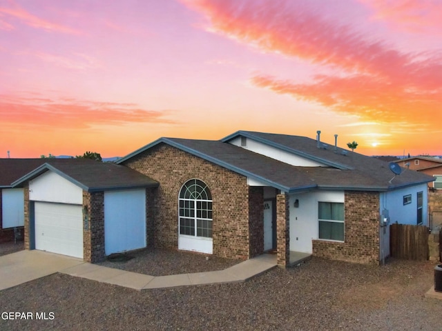 632 Manzanilla Pl, El Paso, TX 79928 - ranch-style home with brick siding, driveway, an attached garage, and roof with shingles