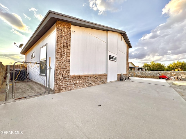 632 Manzanilla Pl, El Paso, TX 79928 - view of home's exterior featuring a patio, a gate, and brick siding