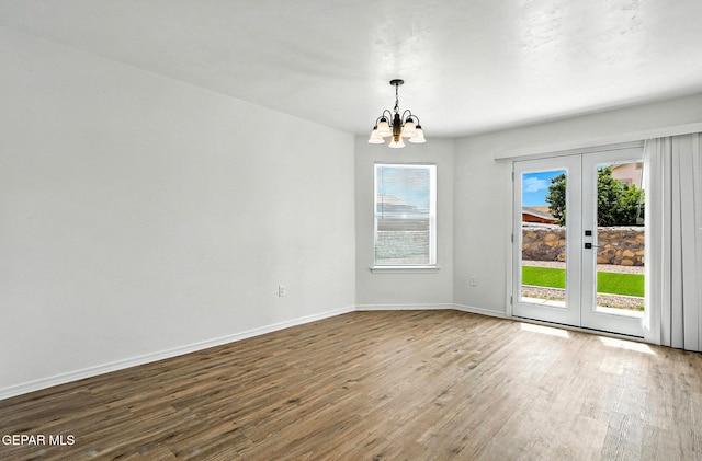 2629 Snowy Rock Pl, El Paso, TX 79938 - empty room with a chandelier, wood finished floors, and french doors