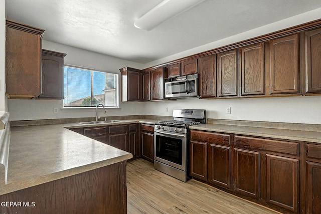 2629 Snowy Rock Pl, El Paso, TX 79938 - kitchen with stainless steel appliances, dark brown cabinetry, and light wood finished floors