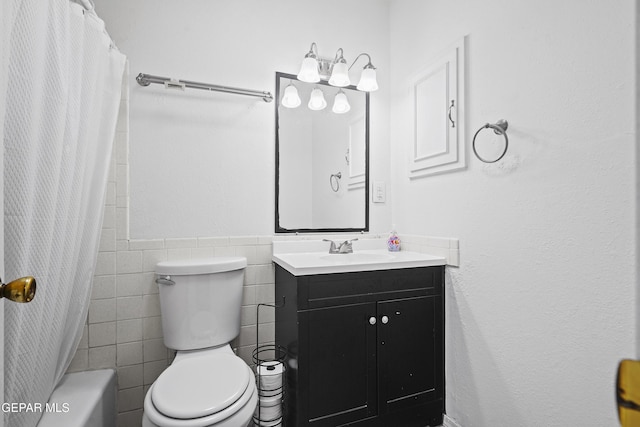 10106 Mercedes St, El Paso, TX 79924 - full bath featuring vanity, tile walls, a wainscoted wall, and shower / bath combo