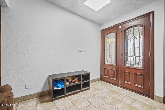 10106 Mercedes St, El Paso, TX 79924 - foyer entrance with french doors, a textured ceiling, and a textured wall