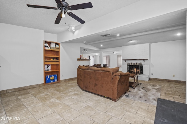 10106 Mercedes St, El Paso, TX 79924 - living area featuring a ceiling fan, a fireplace, a textured ceiling, and recessed lighting