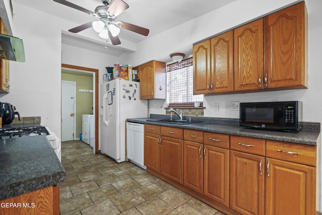 10106 Mercedes St, El Paso, TX 79924 - kitchen featuring white appliances, brown cabinetry, a ceiling fan, and dark countertops