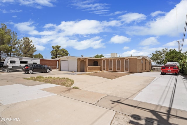 10106 Mercedes St, El Paso, TX 79924 - view of front of house featuring driveway, stucco siding, and an attached garage