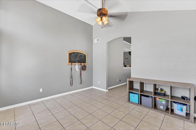 11651 Great Spirit Cir, El Paso, TX 79936 - empty room featuring arched walkways, a ceiling fan, light tile patterned flooring, and lofted ceiling