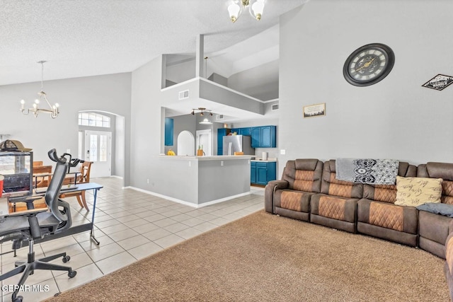 11651 Great Spirit Cir, El Paso, TX 79936 - living area featuring a chandelier, light tile patterned floors, high vaulted ceiling, and a textured ceiling