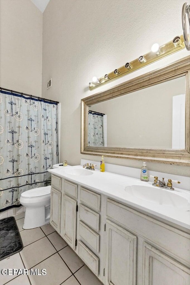 11651 Great Spirit Cir, El Paso, TX 79936 - bathroom with double vanity, tile patterned floors, and a shower with curtain