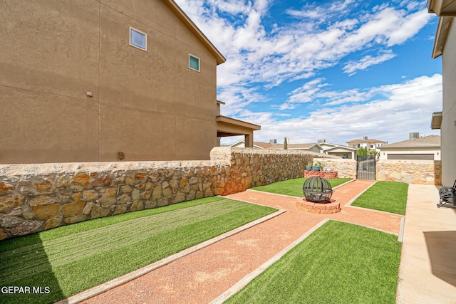 2116 Tim Foster St, El Paso, TX 79938 - view of yard with an outdoor fire pit, a patio, and a gate