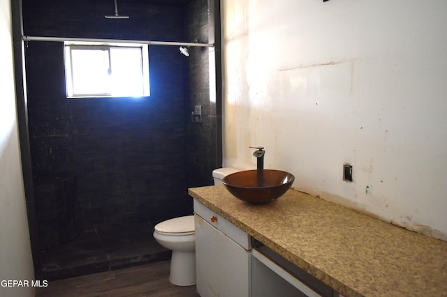 7556 N Loop Dr, El Paso, TX 79915 - full bathroom with a shower, vanity, and wood finished floors