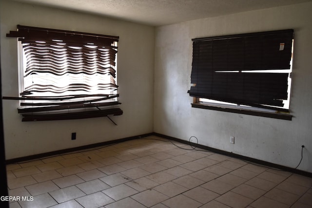 7556 N Loop Dr, El Paso, TX 79915 - spare room with healthy amount of natural light and a textured ceiling