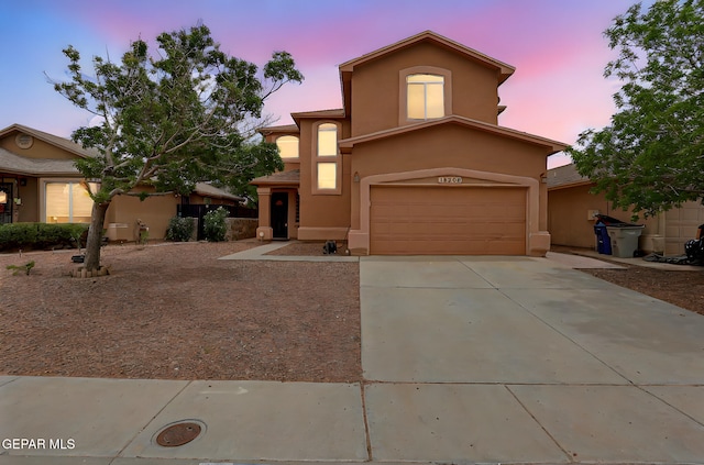 12308 Sombra Grande Dr, El Paso, TX 79938 - mediterranean / spanish house featuring stucco siding, concrete driveway, and an attached garage