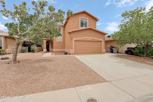 12308 Sombra Grande Dr, El Paso, TX 79938 - view of front facade with stucco siding, an attached garage, and concrete driveway