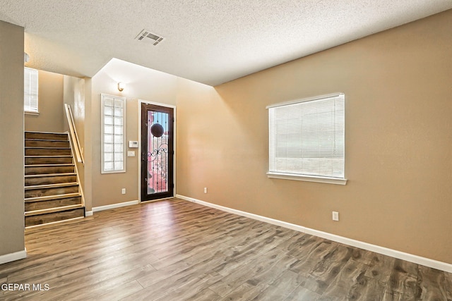 12308 Sombra Grande Dr, El Paso, TX 79938 - entrance foyer featuring wood finished floors, a textured ceiling, and stairs