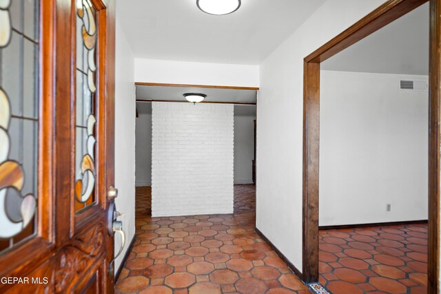 11204 Bob Mitchell Dr, El Paso, TX 79936 - entrance foyer with baseboards and brick wall