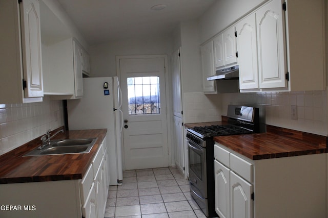5124 Edmonton Ave, El Paso, TX 79924 - kitchen with butcher block counters, gas stove, under cabinet range hood, and tasteful backsplash