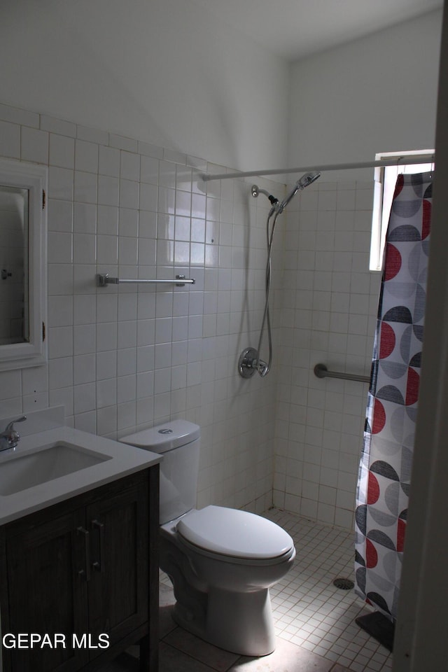 5124 Edmonton Ave, El Paso, TX 79924 - full bath with a stall shower, vanity, tile walls, and tile patterned floors