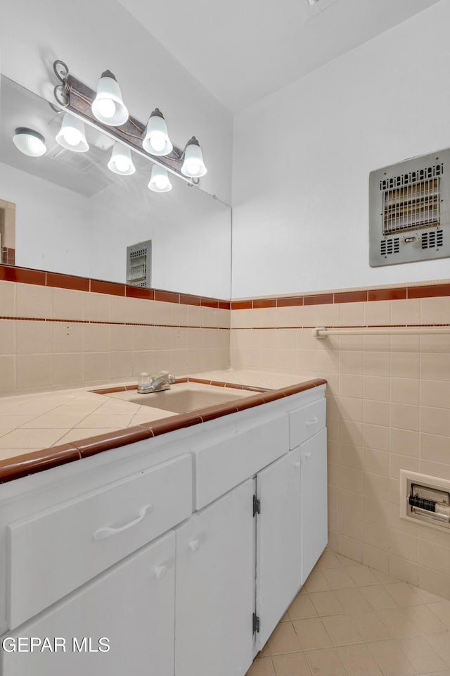 6033 Isabella Dr, El Paso, TX 79912 - bathroom with vanity, tile patterned floors, tile walls, and wainscoting
