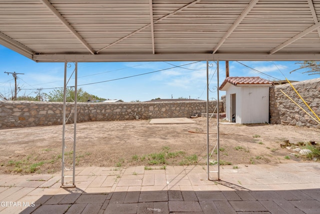6033 Isabella Dr, El Paso, TX 79912 - fenced backyard featuring a patio area and a storage shed