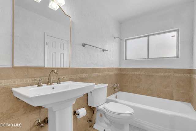 6033 Isabella Dr, El Paso, TX 79912 - bathroom with a bath and tile walls