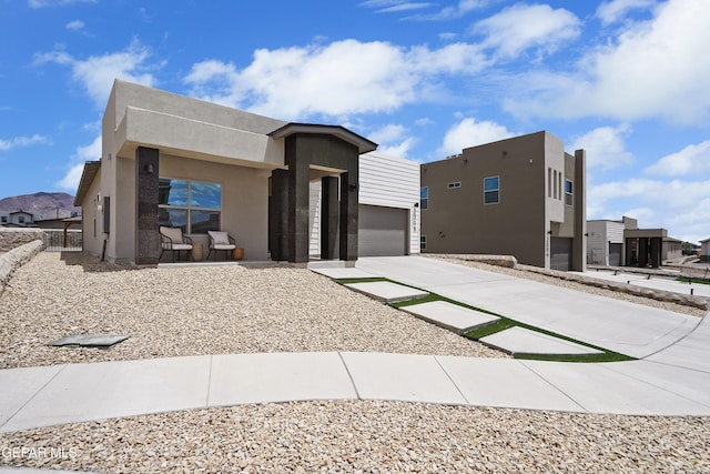 2308 Enchanted Quail, El Paso, TX 79911 - contemporary house with a garage, stucco siding, a residential view, and driveway