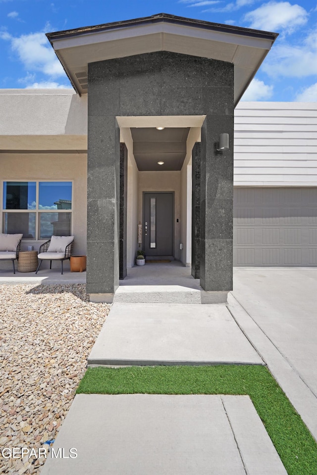 2308 Enchanted Quail, El Paso, TX 79911 - entrance to property with stucco siding, driveway, and a garage