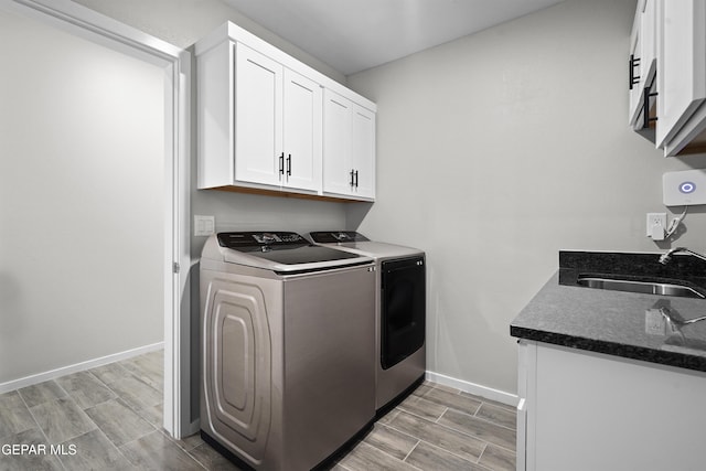 2308 Enchanted Quail, El Paso, TX 79911 - washroom with washing machine and dryer, cabinet space, and wood finish floors