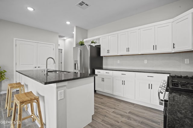 2308 Enchanted Quail, El Paso, TX 79911 - kitchen with stainless steel appliances, white cabinetry, tasteful backsplash, and recessed lighting
