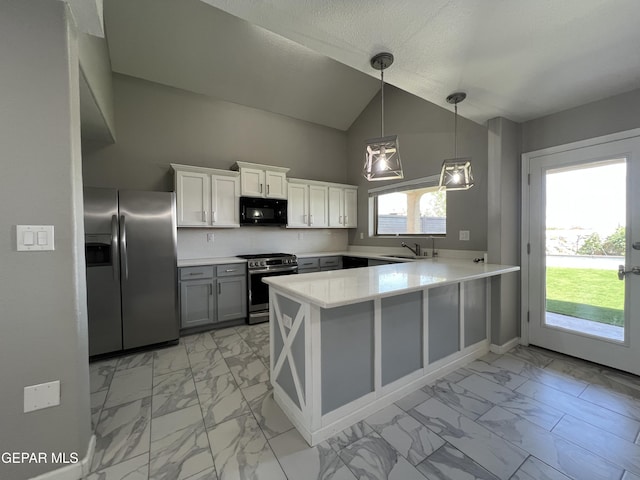 1160 Cielo Mar Dr, Socorro, TX 79927 - kitchen with stainless steel appliances, light marble finish flooring, a peninsula, light countertops, and high vaulted ceiling